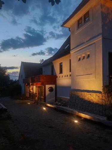 a large white house with lights in front of it at StudioRasnov in Râşnov