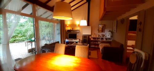 a living room with a wooden table and a living room at CONVINAT in Grand Coo