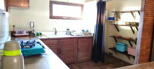 a kitchen with a blue stove and a sink at Villa Nature in Toliara