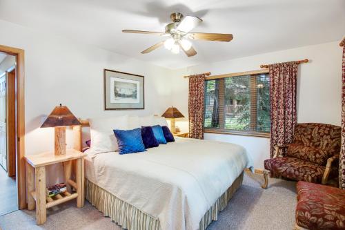 a bedroom with a bed with blue pillows at Cedar House in McCall