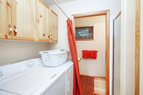 a bathroom with a sink and a washing machine at Cedar House in McCall