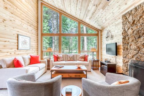 a living room with a couch and chairs and a fireplace at Aspen House 21 in Black Butte Ranch
