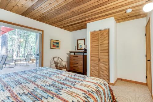 a bedroom with a bed and a sliding glass door at Aspen House 21 in Black Butte Ranch