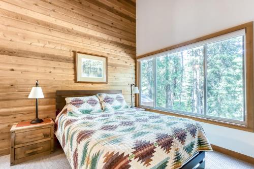 a bedroom with a bed and a large window at Aspen House 21 in Black Butte Ranch