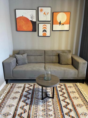 a living room with a couch and a table at Downtown Apartments in Pristina