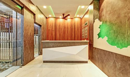 a lobby with a reception desk and a green wall at Itsy Hotels Sri Sai Grand Inn in Vijayawāda