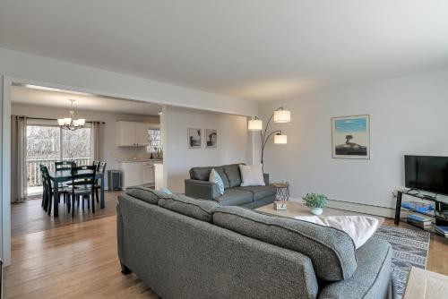 a living room with a couch and a table at 3 BR Private Pondside View New Reno [Moose Lodge] in Bar Harbor