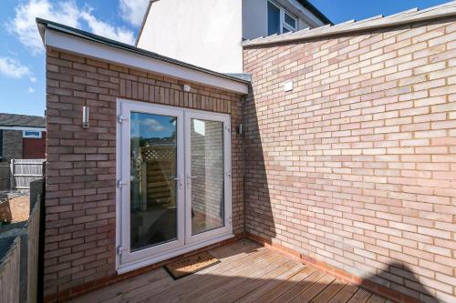 a patio with a sliding glass door on a brick building at King Pin Corner in Stevenage