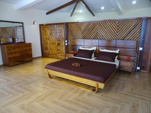 a bedroom with a large bed in a room at Beach Loft in Nosy Be