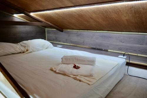 a large white bed with a flower on it at TERMINAL VERDE PRIVATE APARTMENTS NEAR AIRPORT 24h SELF CHECK IN in Concepción