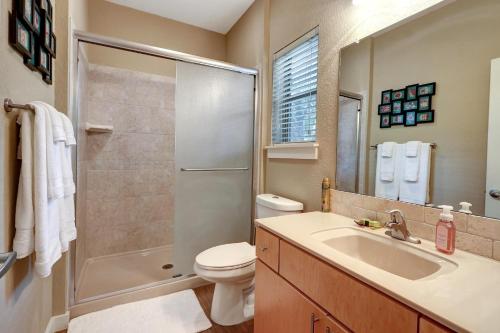 a bathroom with a toilet and a sink and a shower at Three Sisters - Casita 3 in Wimberley