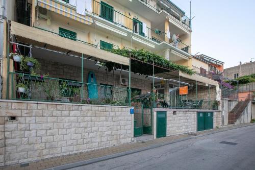 a building with plants on the side of it at Apartment by the sea in Podgora