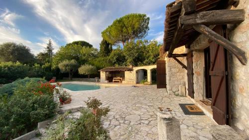 a stone house with a swimming pool in a yard at Villa Azur Star, Vence, French Riviera in Vence
