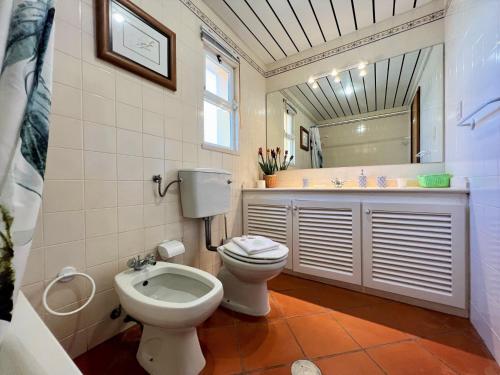 a bathroom with a toilet and a sink at Vilamoura Marina Duplex by Homing in Vilamoura