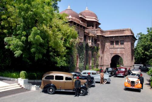 
a car is parked in front of a building at The Ajit Bhawan - A Palace Resort in Jodhpur
