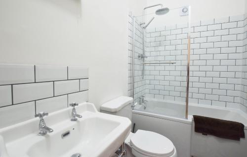 a white bathroom with a toilet and a sink at Modern Apartment In The Centre of Teignmouth in Teignmouth