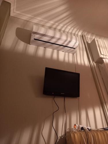a flat screen tv on a wall in a room at Beautiful and Quiet apartment in the centre of Athens in Athens