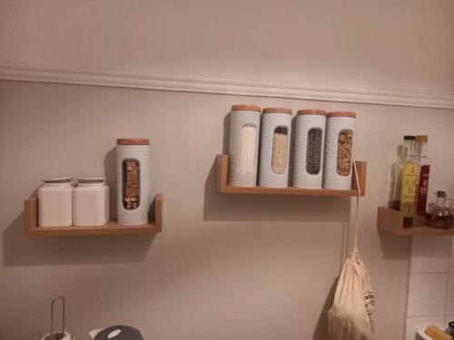 a bathroom with two wooden shelves on the wall at Beautiful and Quiet apartment in the centre of Athens in Athens