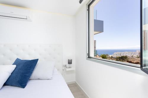 a bedroom with a bed and a large window at Deluxe Apartment in Costa Adeje in Adeje