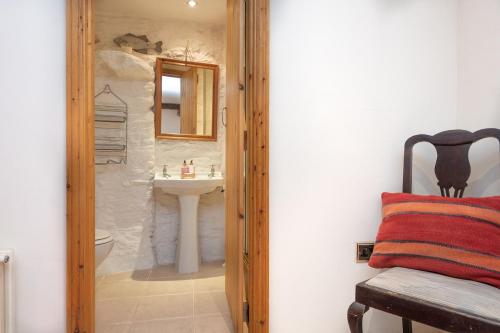 W łazience znajduje się umywalka, toaleta i lustro. w obiekcie The Lookout - A Great Adventure w mieście Kingsbridge