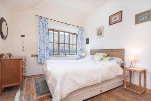a bedroom with a bed and a window at The Lookout - A Great Adventure in Kingsbridge