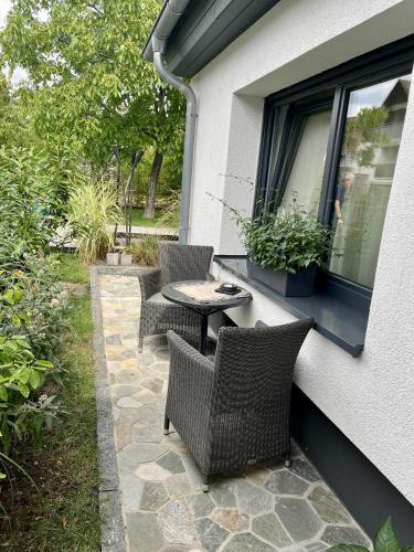 a patio with chairs and a table and a window at Gästehaus Grüne Oase in Fulda