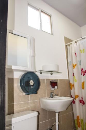 a bathroom with a sink and a toilet and a window at Soga Hostal in Santa Marianita