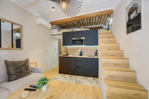 Il comprend un salon avec un escalier, un canapé et une cuisine. dans l'établissement Duplex Studio Apt Mezzanine near Shops & Cafes, à Antibes
