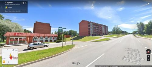 an empty street with a car on the road at Feelings Apartment apartamenti Smiltene in Smiltene