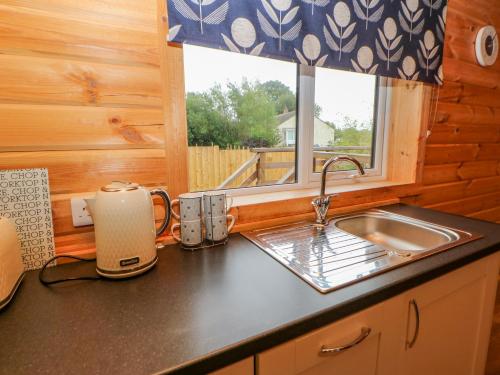 a kitchen counter with a sink and a window at Curlew in Barnard Castle