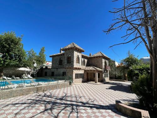 a large stone house with a swimming pool at Casa Rural La Moraleja in Villanueva del Arzobispo