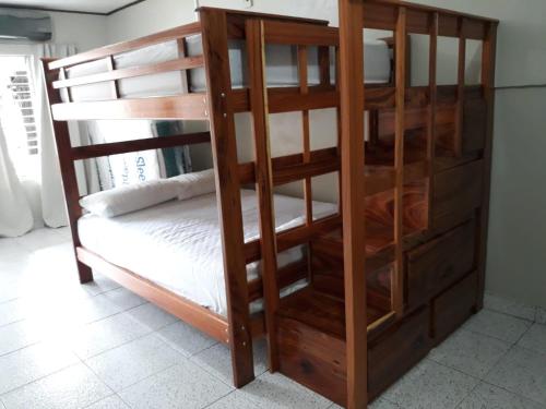 a bunk room with a bunk bed with a wooden bunk bed frame at Apartamento AMUEBLADO in Canoas