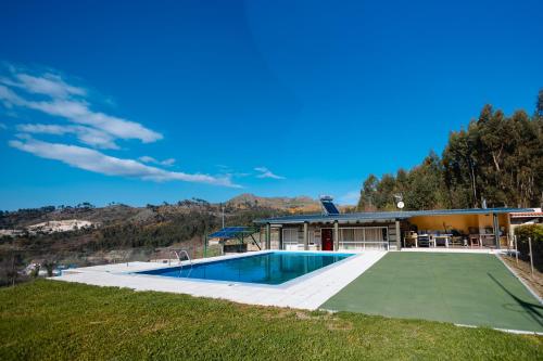 a house with a swimming pool and a mountain at Sorte do Castelo in Marco de Canavezes