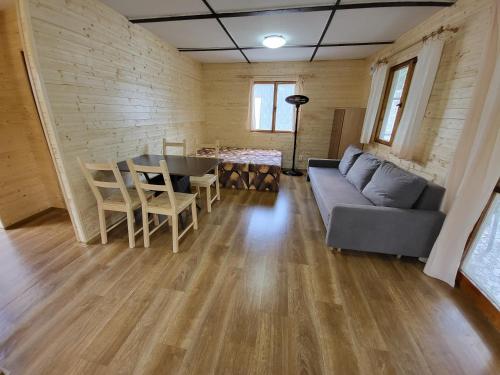 a living room with a couch and a table and chairs at Toska rekreační středisko in Prostřední Bečva