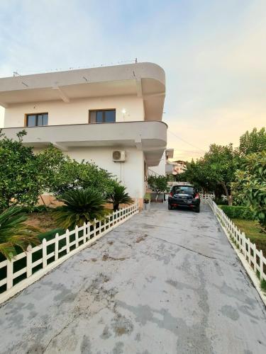 a car parked in front of a house at GUEST HOUSE VILA ELEZI in Durrës