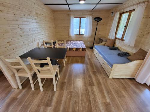 a room with a table and chairs and a couch at Toska rekreační středisko in Prostřední Bečva