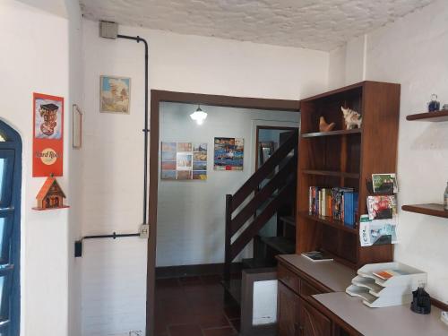 a room with a staircase and a book shelf at Passa Quatro- CASA INTEIRA RUSTICA para até 9 pessoas in Passa Quatro