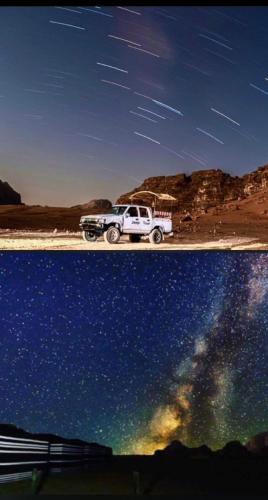 a white truck parked on a beach with the sky at RUM STARDUST lUXURY CAMP in Wadi Rum