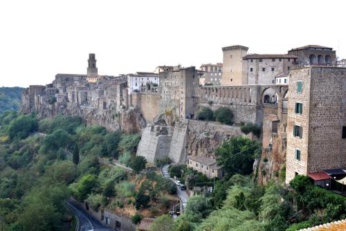 an old castle on a mountain with a road at il Cantuccio in Pitigliano