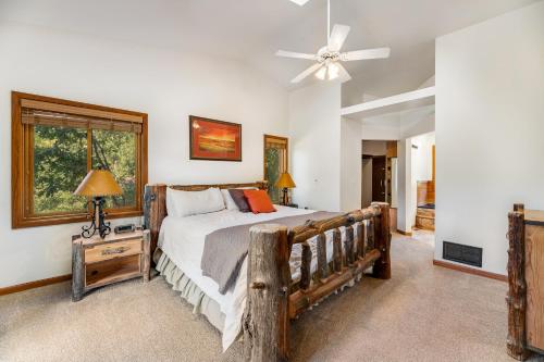 a bedroom with a bed and a ceiling fan at Aces and Eights Lodge in Sturgis