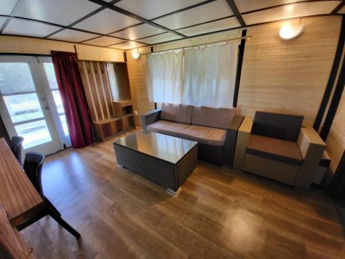 a living room with a couch and a table at Toska rekreační středisko in Prostřední Bečva