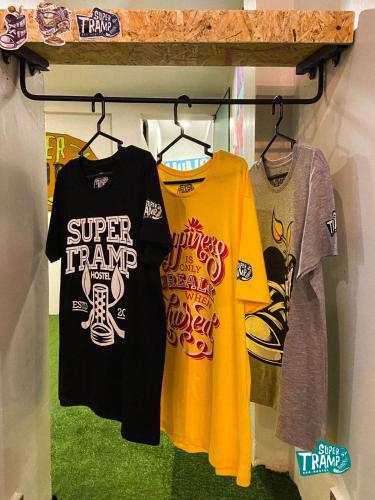 a group of shirts hanging on a shelf at Supertramp Hostel Machupicchu in Machu Picchu