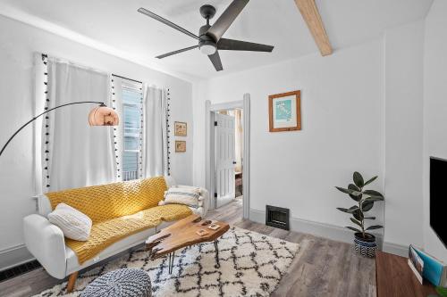 a living room with a couch and a ceiling fan at Center of Little Italy #2 in Cleveland