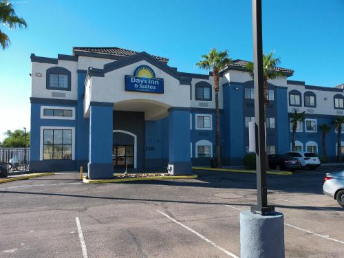 a blue and white building with a sign on it at Days Inn & Suites by Wyndham Tucson/Marana in Tucson