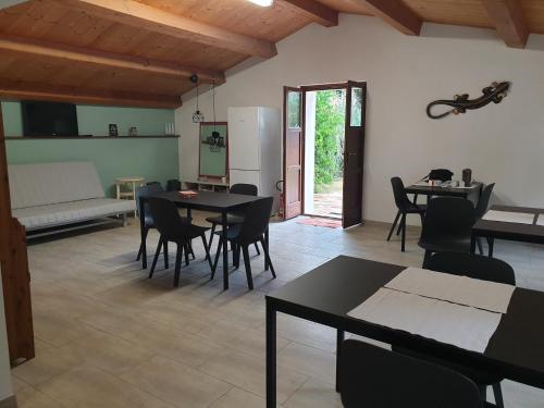 a living room with tables and chairs and a couch at Casale di Maro in Monte Giberto