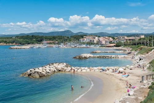a group of people on a beach in the water at appartement en résidence vue mer , piscine… in Six-Fours-les-Plages