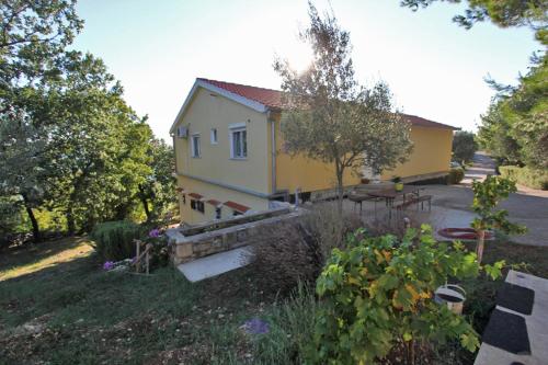 a small yellow house with a picnic table in front of it at Beachfront House Nella with full privacy in Jasenice