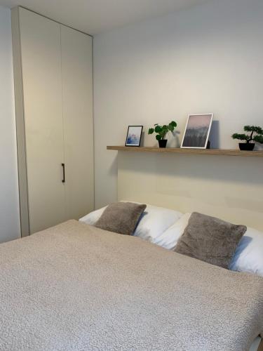 a bedroom with a bed and two laptops on a shelf at Apartmány Valča in Valča