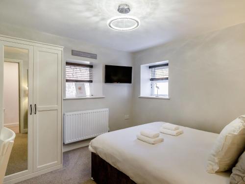 a bedroom with a bed with two towels on it at Queen Anne Suite in Stanhope