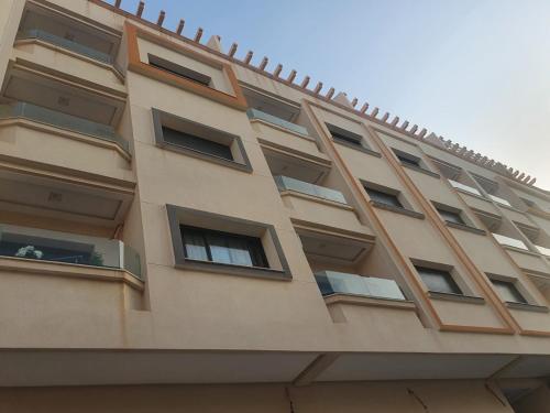 a building with windows on the side of it at Nador hay al Matar in Nador